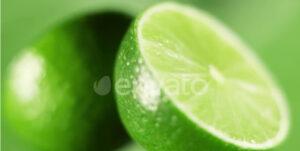 The Fresh Limes are Rotating Slowly on Bright Green Background